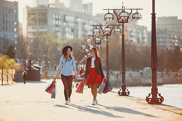 Image showing Two girls walking with shopping on city streets