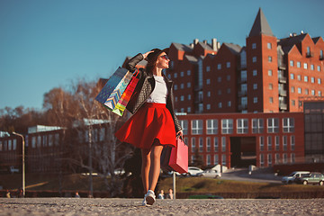 Image showing The girl walking with shopping on city streets