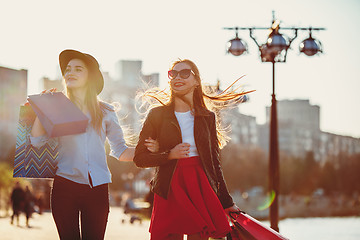 Image showing Two girls walking with shopping on city streets