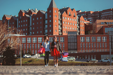 Image showing Two girls walking with shopping on city streets