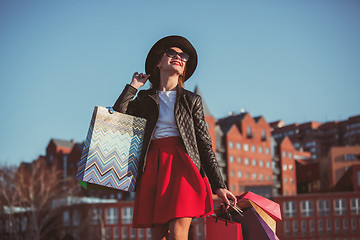 Image showing The girl walking with shopping on city streets