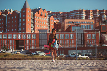 Image showing The girl walking with shopping on city streets