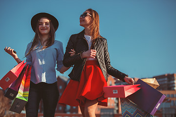 Image showing Two girls walking with shopping on city streets