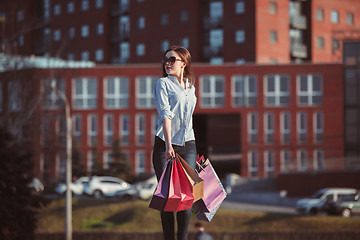 Image showing The girl walking with shopping on city streets