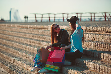 Image showing Two girls walking with shopping on city streets