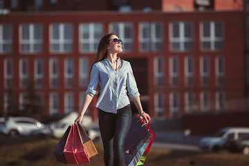 Image showing The girl walking with shopping on city streets