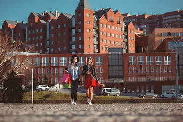 Image showing Two girls walking with shopping on city streets