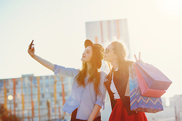 Image showing Two girls walking with shopping on city streets