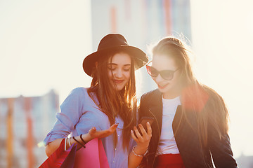 Image showing Two girls walking with shopping on city streets