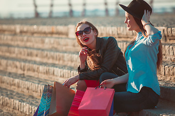 Image showing Two girls walking with shopping on city streets