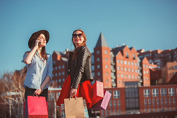 Image showing Two girls walking with shopping on city streets