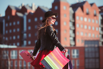 Image showing The girl walking with shopping on city streets