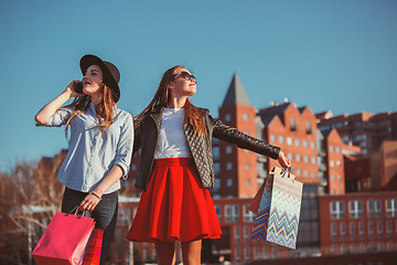 Image showing Two girls walking with shopping on city streets