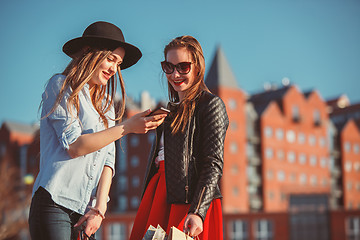 Image showing Two girls walking with shopping on city streets