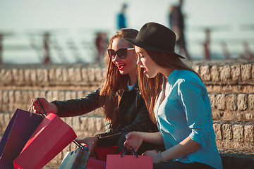 Image showing Two girls walking with shopping on city streets