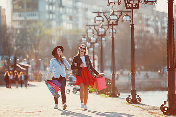 Image showing Two girls walking with shopping on city streets