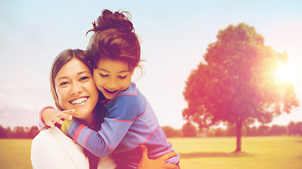 Image showing happy mother and daughter hugging outdoors