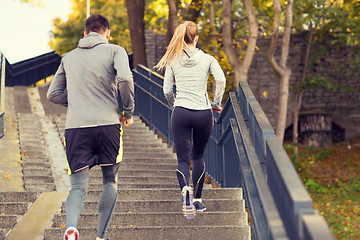 Image showing couple running upstairs in city park