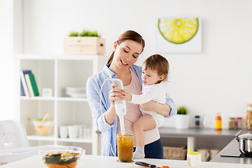 Image showing happy mother and baby cooking food at home kitchen