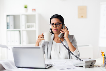 Image showing businesswoman calling on phone at office