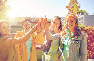 Image showing happy students or friends making high five