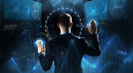 Image showing businessman touching virtual screen