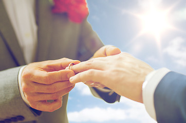 Image showing close up of male gay couple hands and wedding ring