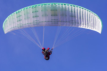 Image showing Paragliding in tandem, extreme sport, free gliding and blue sky 