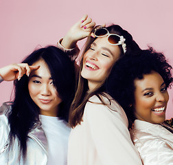 Image showing different nation girls with diversuty in skin, hair. Asian, scandinavian, african american cheerful emotional posing on pink background, woman day celebration, lifestyle people concept 