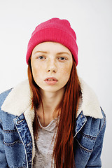 Image showing young pretty teenage hipster girl posing emotional happy smiling on white background, lifestyle people concept 