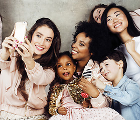 Image showing Lifestyle and people concept: young pretty diversity nations woman with different age children celebrating on birth day party together happy smiling, making selfie. African-american, asian and caucasi