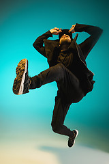 Image showing The silhouette of one hip hop male break dancer dancing on colorful background