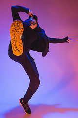 Image showing The silhouette of one hip hop male break dancer dancing on colorful background