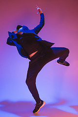 Image showing The silhouette of one hip hop male break dancer dancing on colorful background