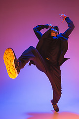 Image showing The silhouette of one hip hop male break dancer dancing on colorful background