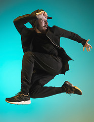 Image showing The silhouette of one hip hop male break dancer dancing on colorful background