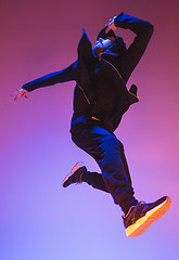 Image showing The silhouette of one hip hop male break dancer dancing on colorful background