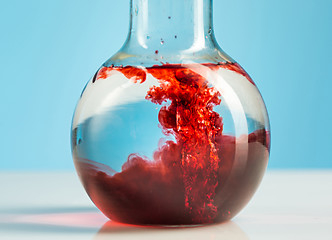Image showing The laboratory glassware and red liquid inside on white