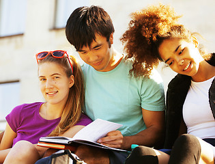 Image showing cute group of teenages at the building of university with books huggings