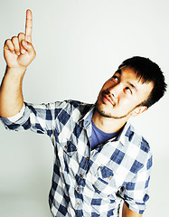 Image showing young cute asian man on white background gesturing emotional, po