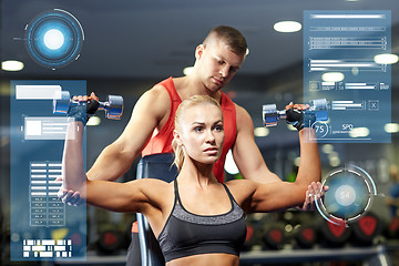 Image showing man and woman with dumbbells in gym