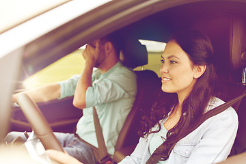 Image showing woman driving car and man covering face with palm