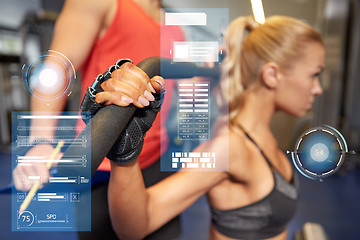 Image showing man and woman flexing muscles on gym machine