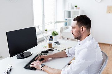 Image showing businessman typing on computer keyboard at office