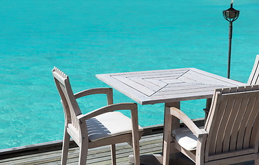 Image showing table and chairs at restaurant terrace over sea