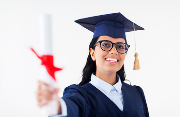 Image showing happy bachelor woman in mortarboard with diplomas