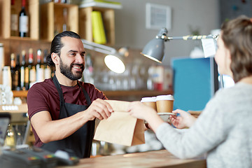 Image showing man or waiter serving customer at coffee shop
