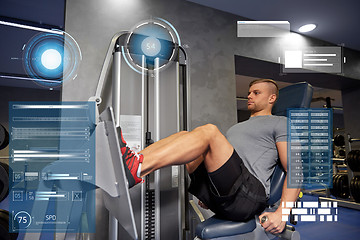 Image showing man flexing leg muscles on gym machine