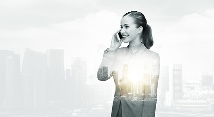 Image showing smiling businesswoman calling on smartphone