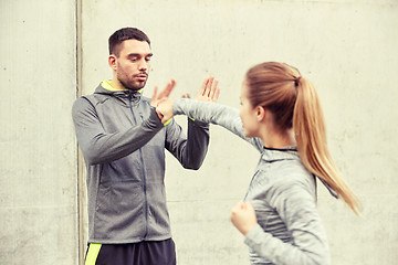 Image showing woman with trainer working out self defense strike